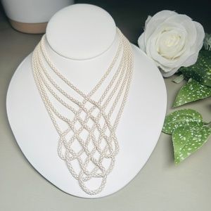 Express creamy white enameled woven metal fashion necklace.